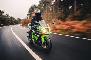 driving green neon color motorcycle on the road